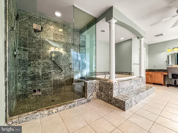 a spacious bathroom with a shower and a sink