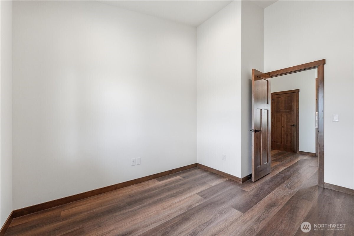 110 Slide View Lane Manson, WA 98831 - Photo 18 of 38 a view of an empty room with wooden floor and closet