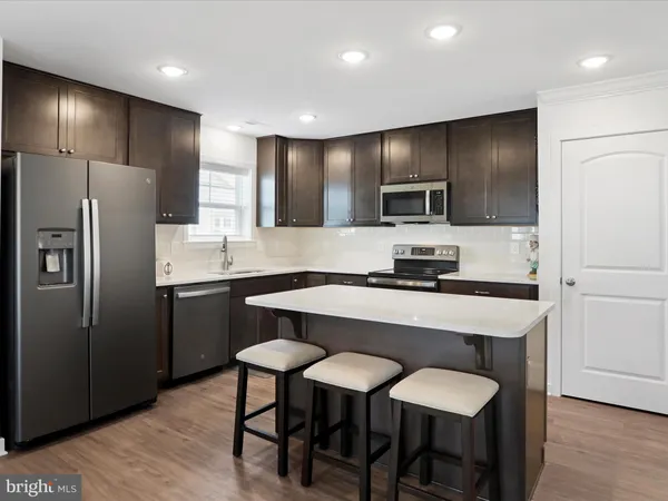a kitchen with stainless steel appliances a refrigerator stove microwave and cabinets