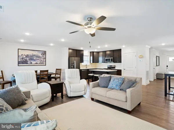 a living room with furniture and kitchen view