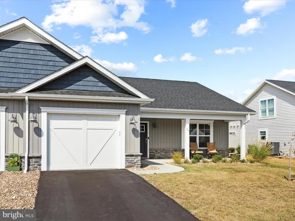 a front view of a house with yard and porch