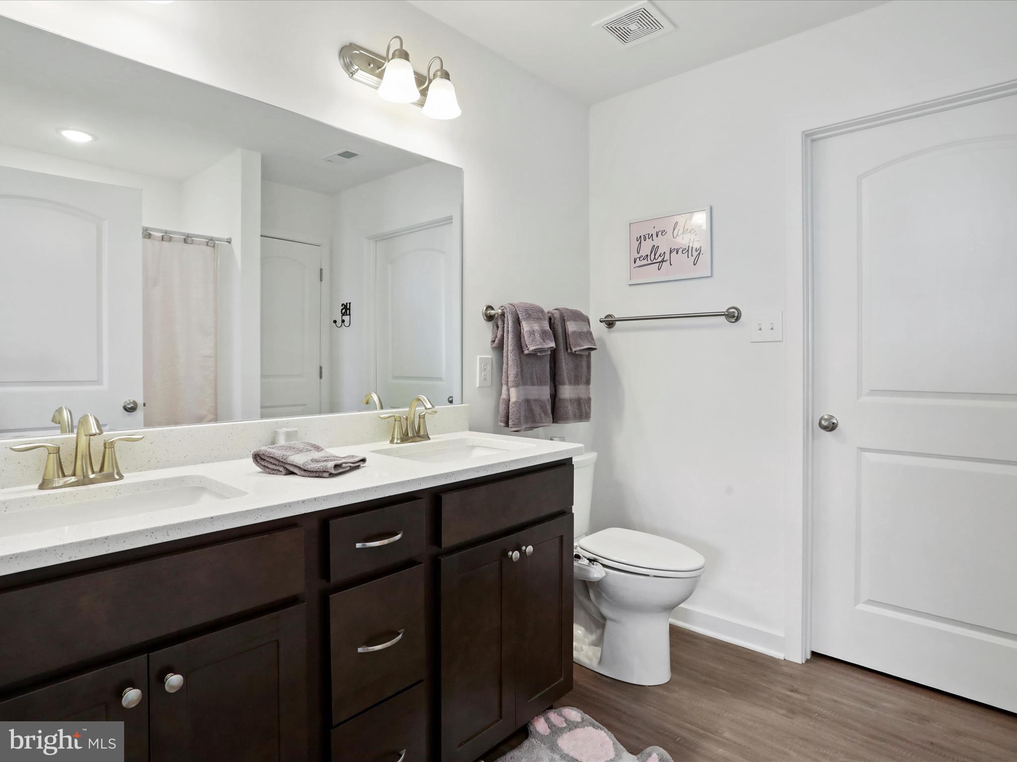 791 Dripping Spring Drive Hammondsville, OH 43930 - Photo 22 of 33 a bathroom with a granite countertop sink a toilet and a mirror