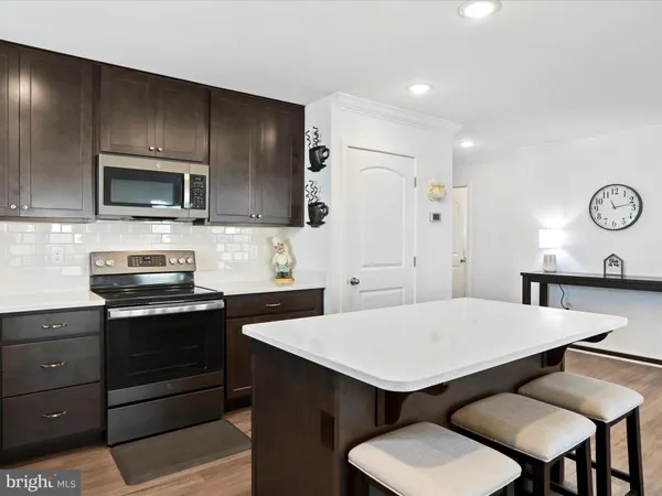 a kitchen with a dining table and chairs