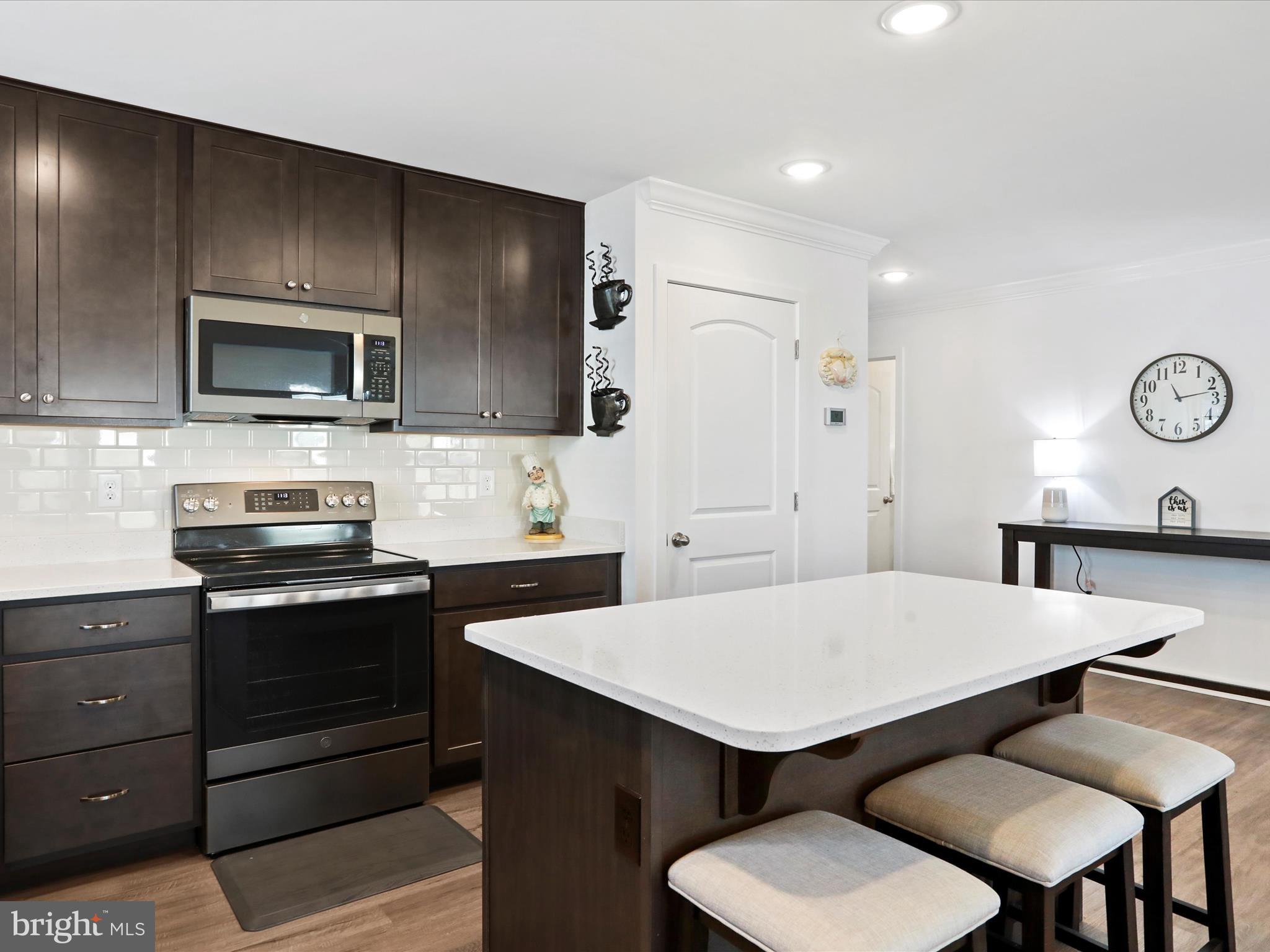 791 Dripping Spring Drive Hammondsville, OH 43930 - Photo 10 of 33 a kitchen with a dining table and chairs
