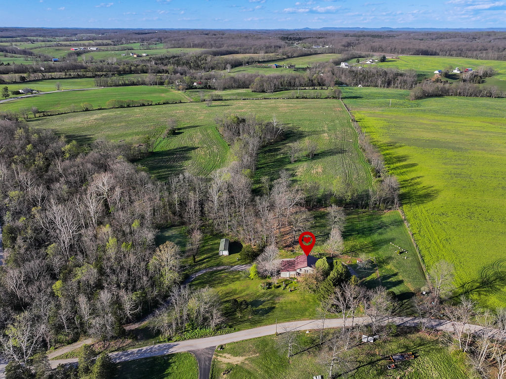 100 Nichols Ridge Road Seaman, OH 45679 - Photo 4 of 43 An aerial view showcases a serene rural landscape with verdant fields and a charming residence.