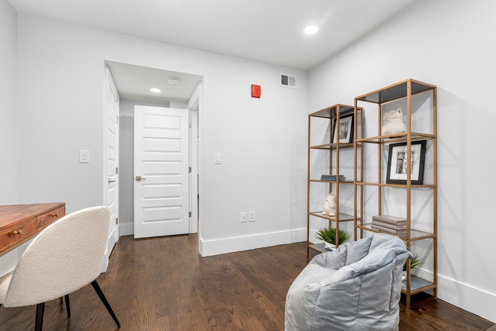 111 Winthrop Road, Unit 1 Brookline, MA 02445 - Photo 18 of 20 a livingroom with furniture and a book shelf