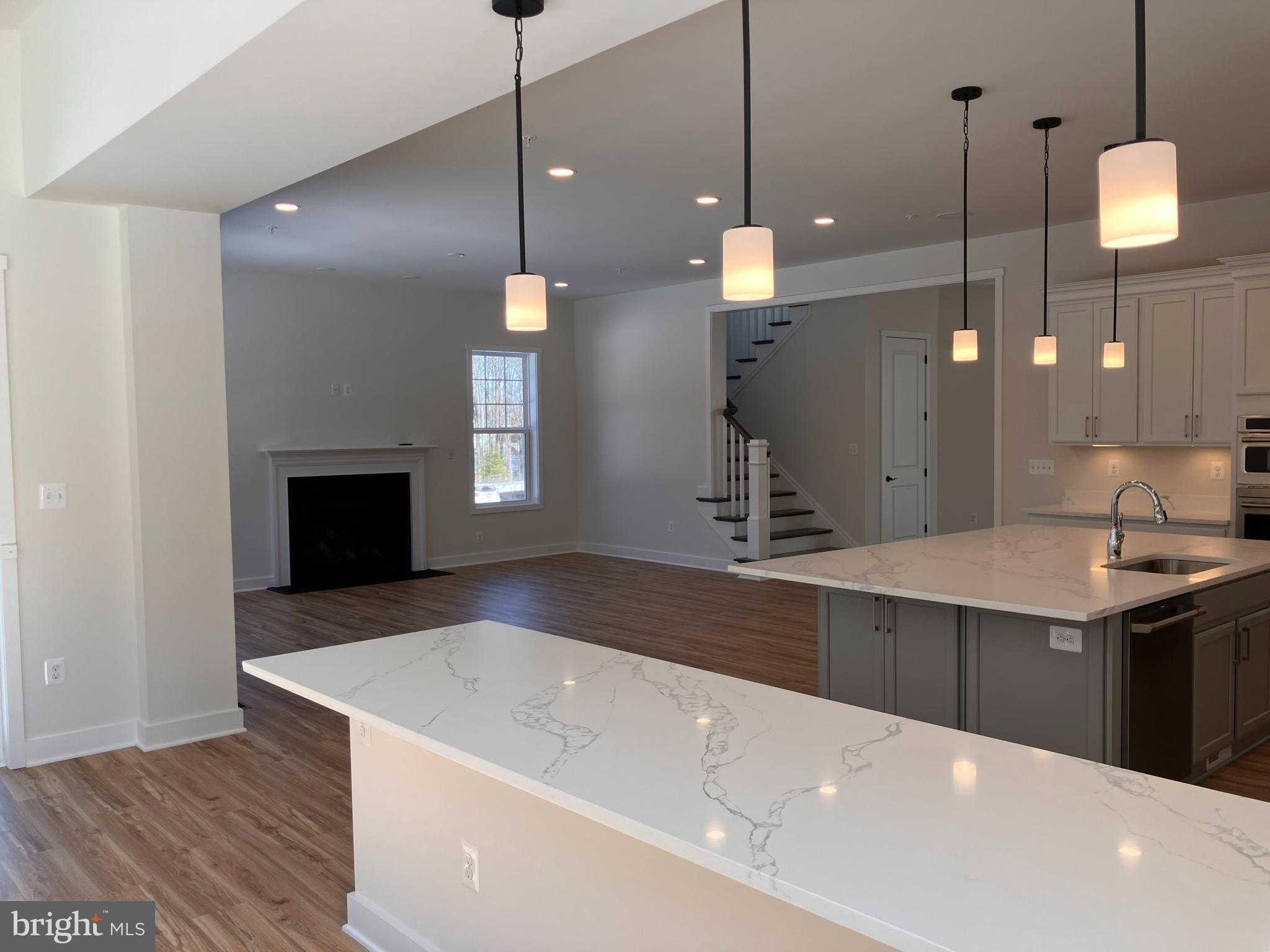 7327 Wisteria Point Drive, Unit 34 Hanover, MD 21076 - Photo 14 of 36 a large kitchen with kitchen island a sink stainless steel appliances and wooden floor