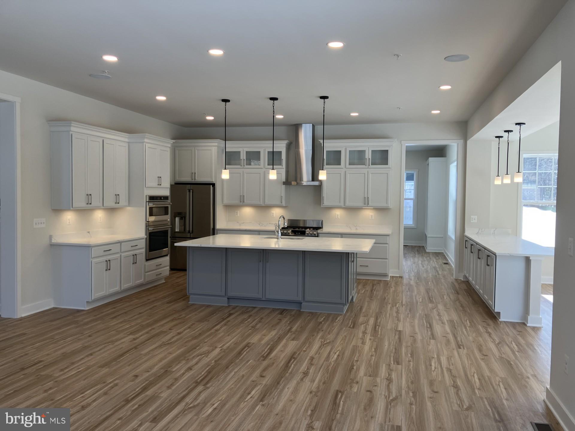 7327 Wisteria Point Drive, Unit 34 Hanover, MD 21076 - Photo 15 of 36 a large kitchen with kitchen island a island in the center