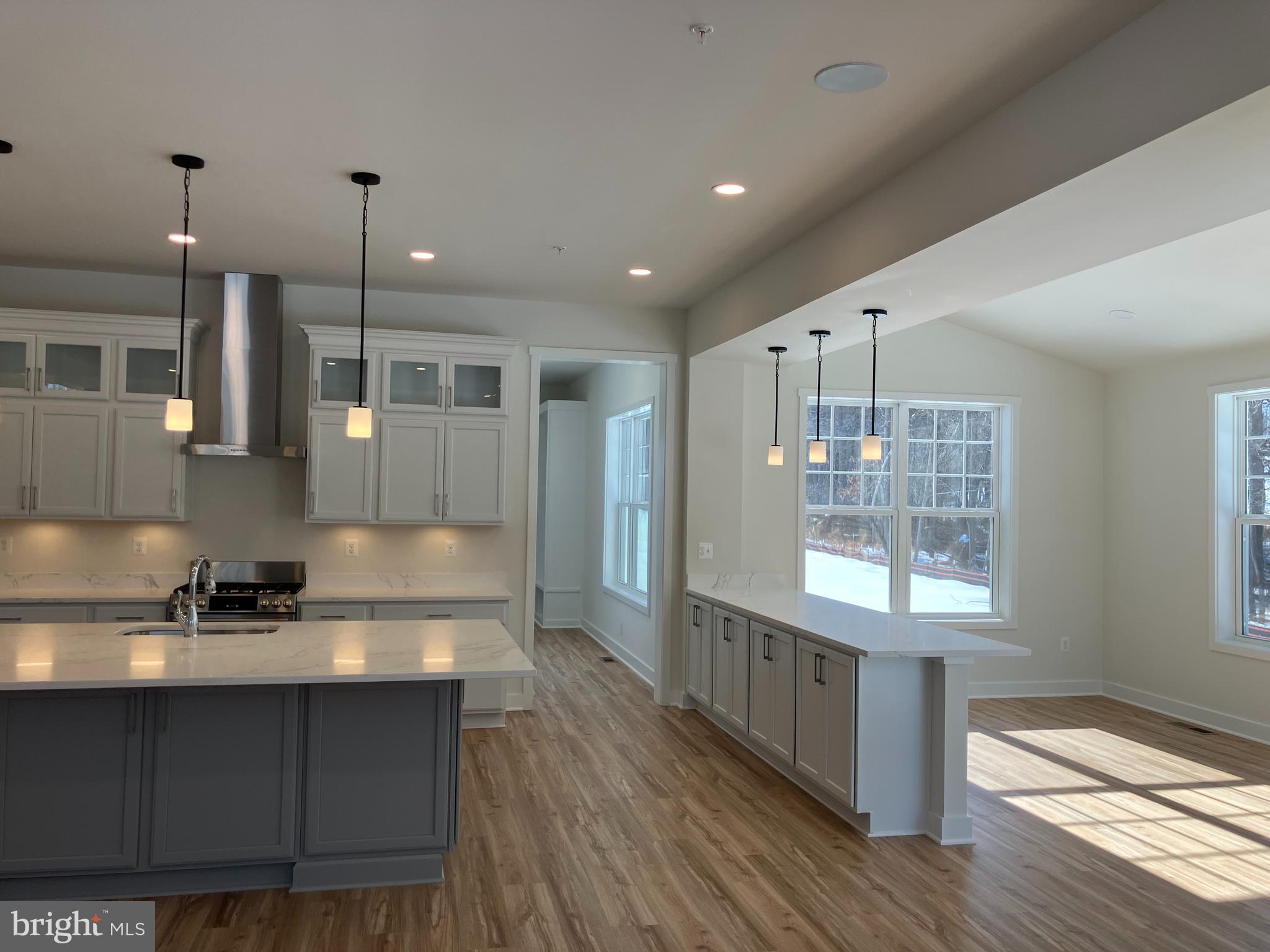 7327 Wisteria Point Drive, Unit 34 Hanover, MD 21076 - Photo 17 of 36 a kitchen with stainless steel appliances granite countertop a sink a stove and a wooden floors