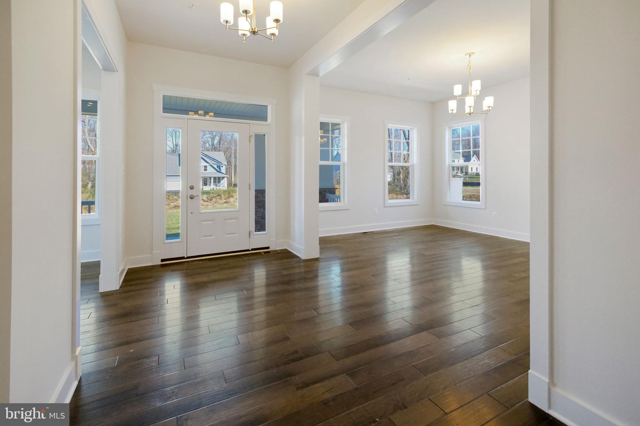 7327 Wisteria Point Drive, Unit 34 Hanover, MD 21076 - Photo 2 of 36 a view of an empty room with wooden floor and a window
