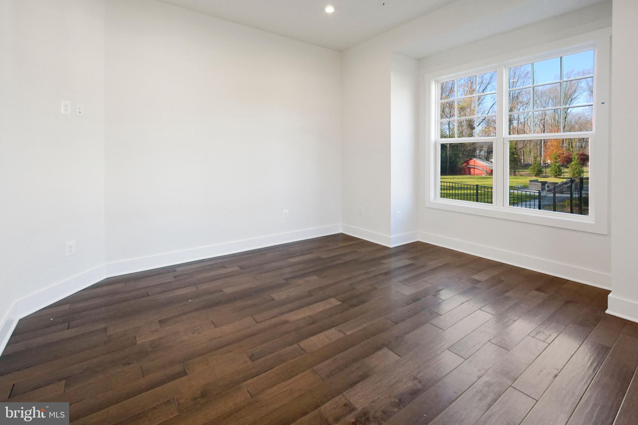 7327 Wisteria Point Drive, Unit 34 Hanover, MD 21076 - Photo 4 of 36 an empty room with wooden floor and windows