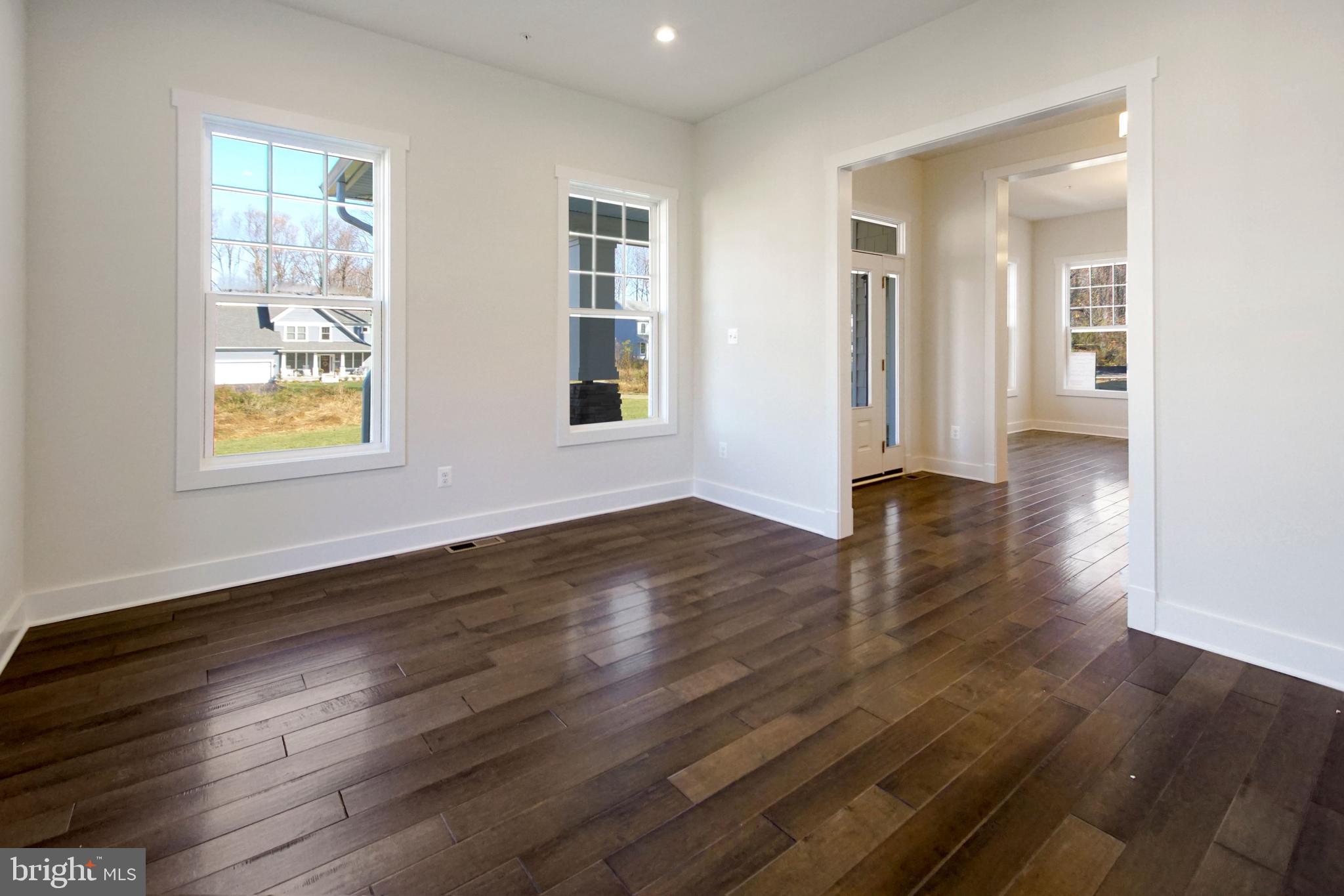 7327 Wisteria Point Drive, Unit 34 Hanover, MD 21076 - Photo 5 of 36 a view of an empty room with wooden floor and a window