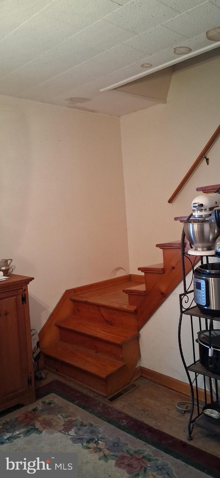 1927 Cumberland Road Bedford, PA 15522 - Photo 42 of 61 a room with table closet and wooden floor