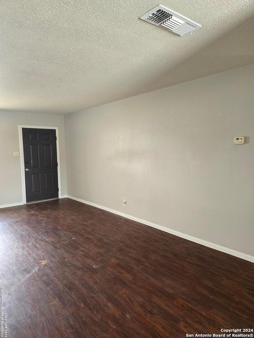 a view of an empty room and wooden floor