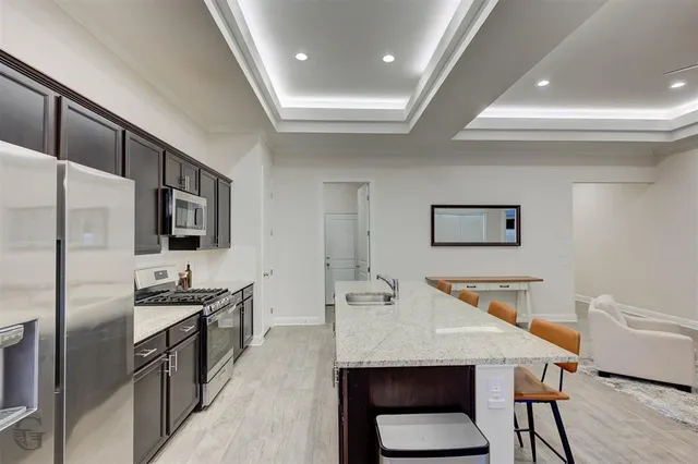 a kitchen with stainless steel appliances a microwave a stove and refrigerator