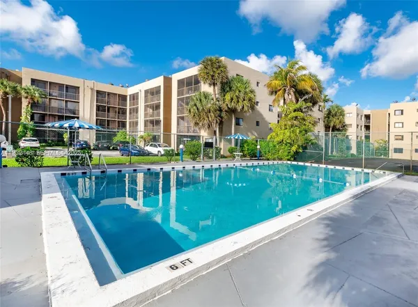 a view of swimming pool with outdoor seating and city view