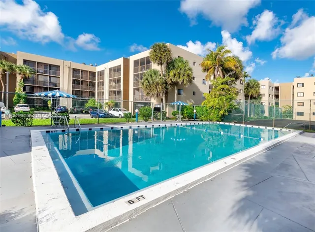a view of swimming pool with outdoor seating and city view