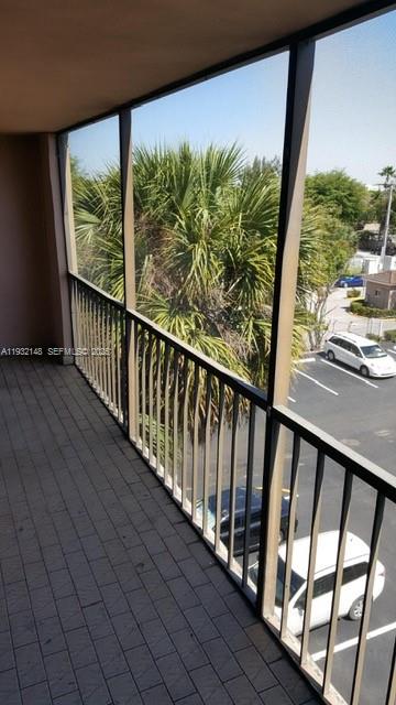 8625 Northwest 8th Street, Unit 401 Miami, FL 33126 - Photo 11 of 12 a view of balcony with wooden floor