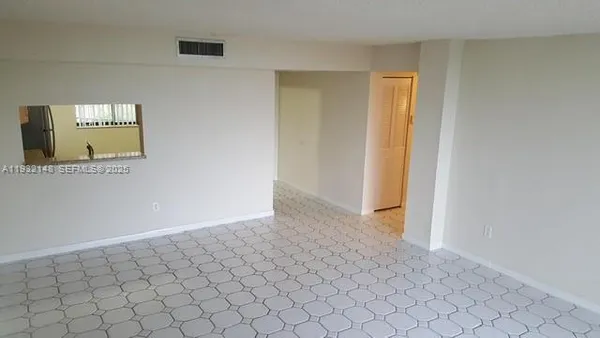 a view of an empty room and window