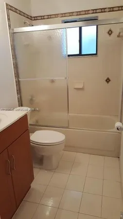 a bathroom with a toilet a sink and shower