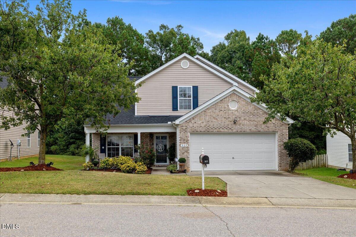 505 Pyracantha Drive Holly Springs, NC 27540 - Photo 1 of 41 a front view of a house with a yard and garage