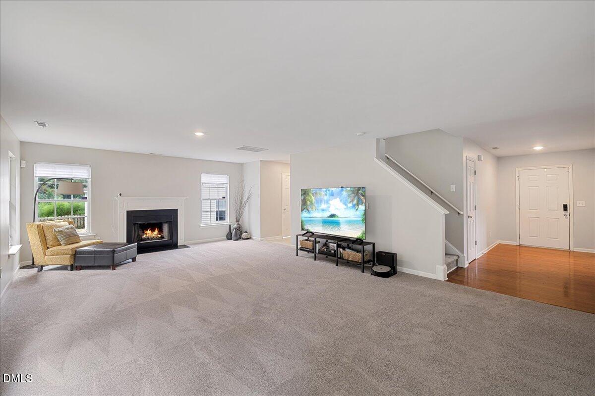 505 Pyracantha Drive Holly Springs, NC 27540 - Photo 8 of 41 a view of a livingroom with furniture and a fireplace