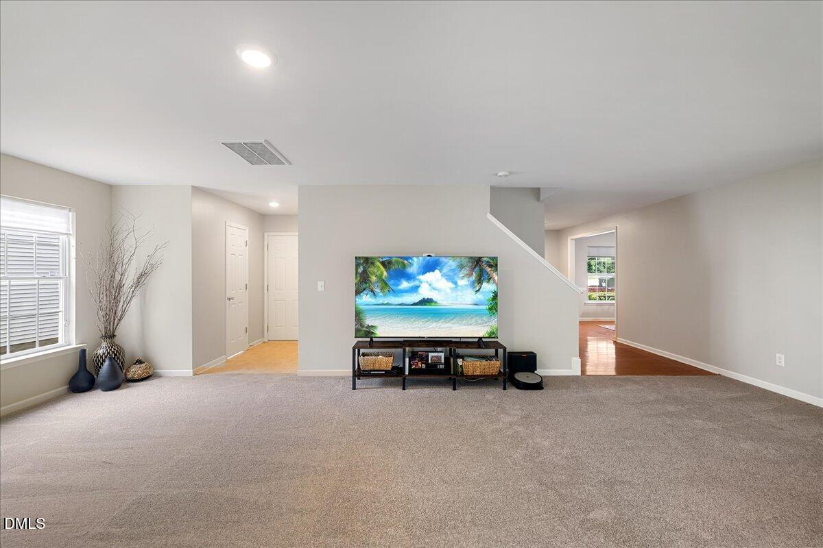 505 Pyracantha Drive Holly Springs, NC 27540 - Photo 9 of 41 an empty room with furniture and a window