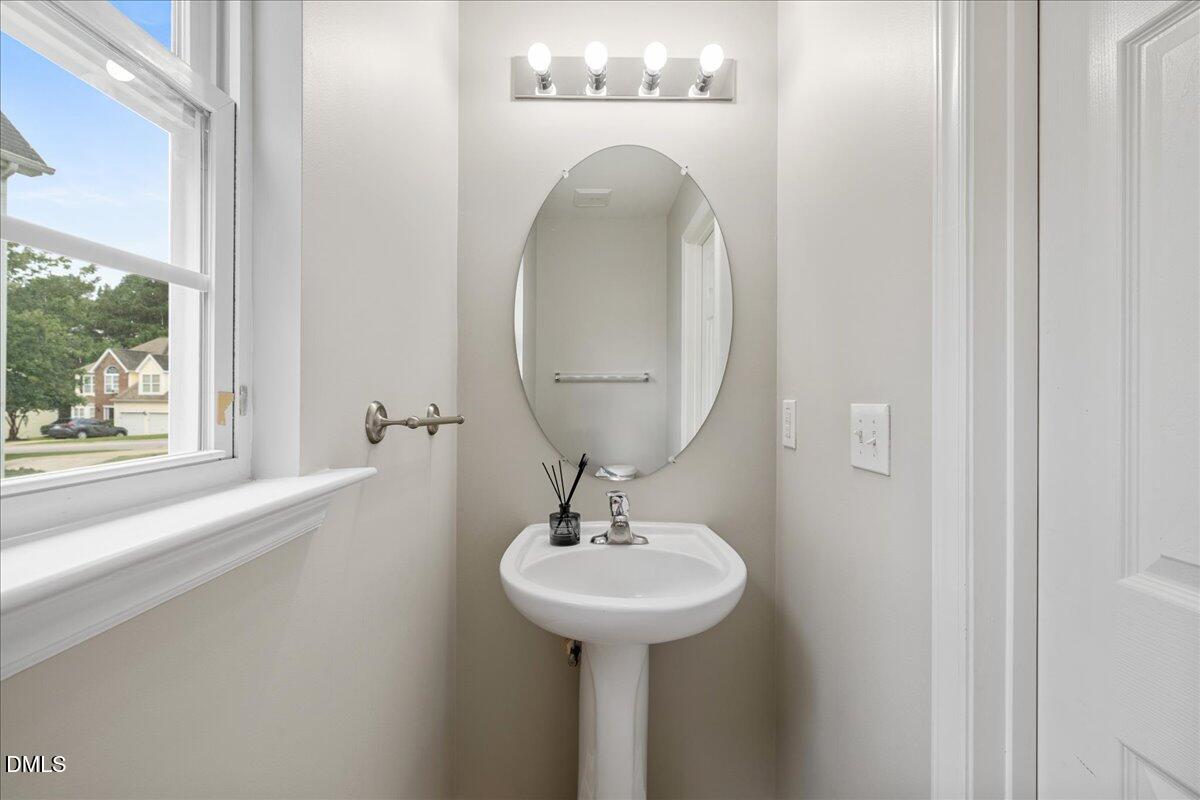 505 Pyracantha Drive Holly Springs, NC 27540 - Photo 12 of 41 a bathroom with a sink and a mirror