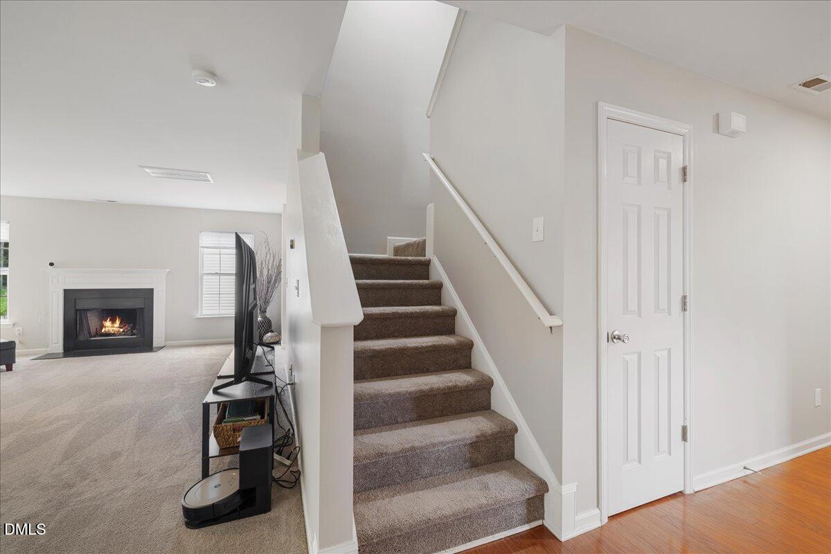 505 Pyracantha Drive Holly Springs, NC 27540 - Photo 16 of 41 a view of a livingroom with a fireplace and entryway
