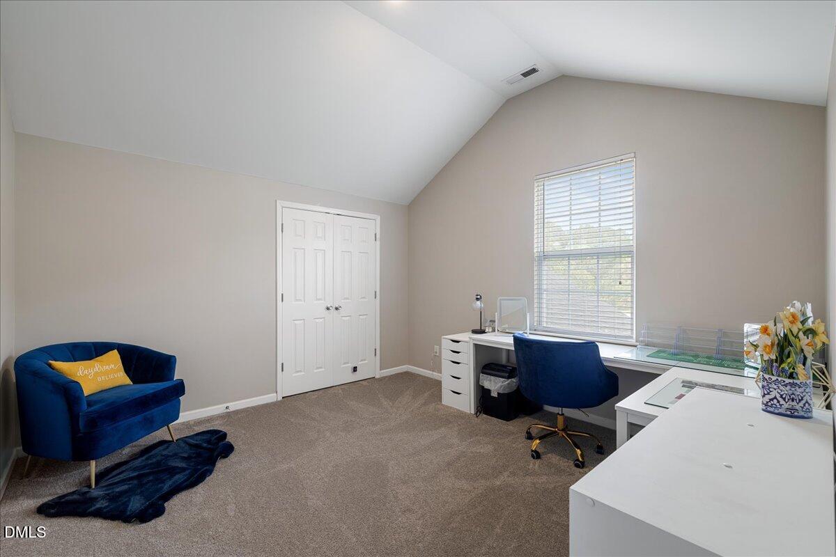 505 Pyracantha Drive Holly Springs, NC 27540 - Photo 19 of 41 a livingroom with workspace and a window