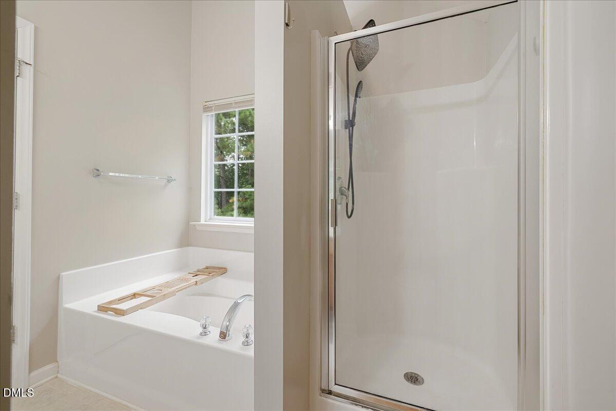 505 Pyracantha Drive Holly Springs, NC 27540 - Photo 23 of 41 a bathroom with a tub and shower