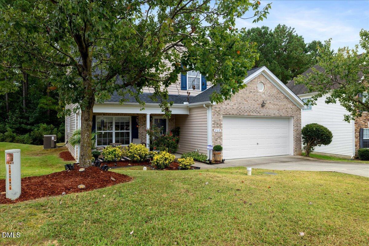 505 Pyracantha Drive Holly Springs, NC 27540 - Photo 2 of 41 a front view of a house with a yard and garage