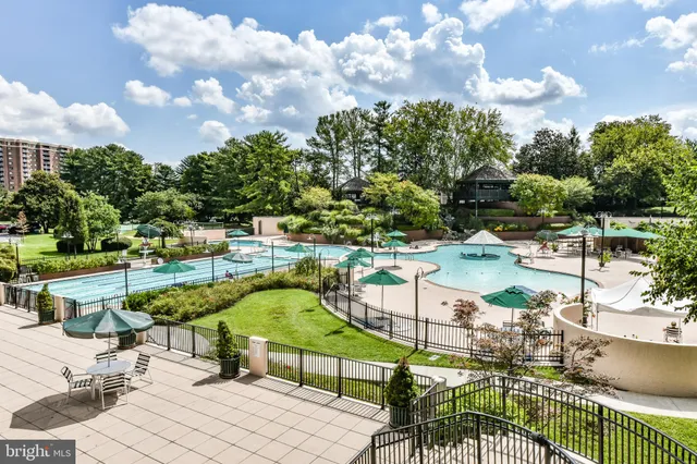 a swimming pool with outdoor seating and yard