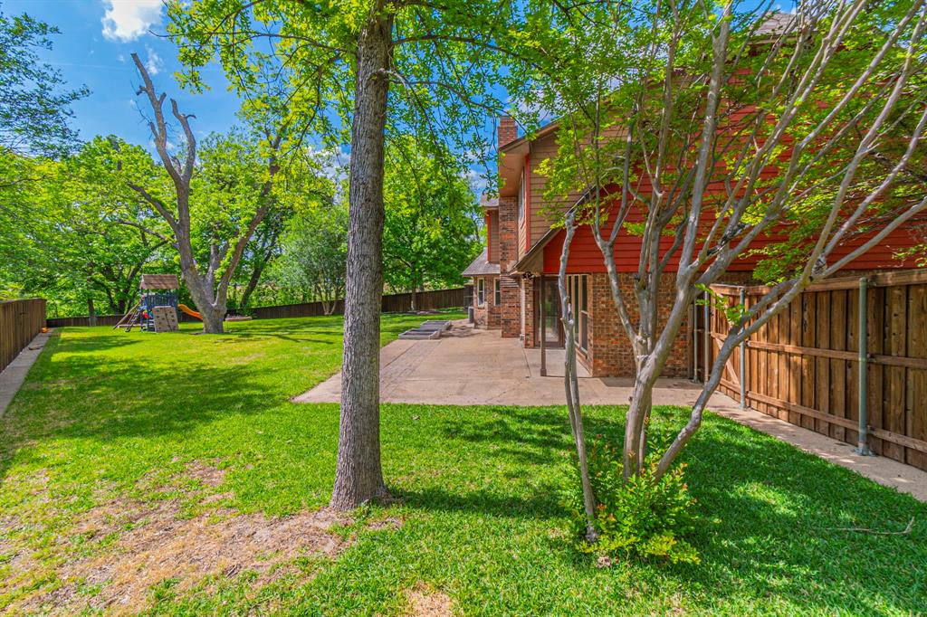127 Nicklaus Nook Lancaster, TX 75146 - Photo 32 of 37 Fenced backyard featuring a patio and a playground