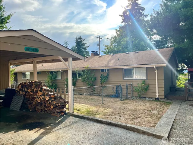 a kitchen with a table chairs and a refrigerator