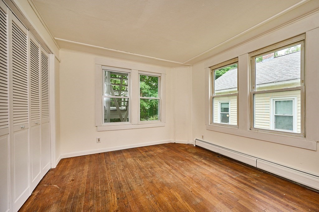 19 Powell Street Northampton, MA 01062 - Photo 11 of 40 a view of an empty room with wooden floor and a window