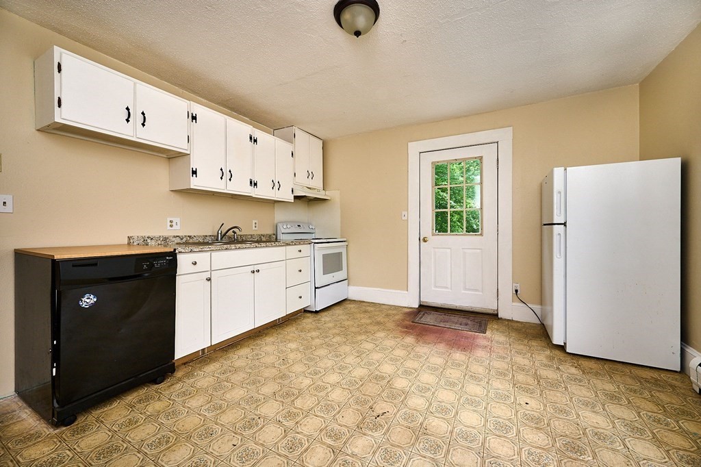19 Powell Street Northampton, MA 01062 - Photo 14 of 40 a kitchen with stainless steel appliances cabinets a sink and a refrigerator
