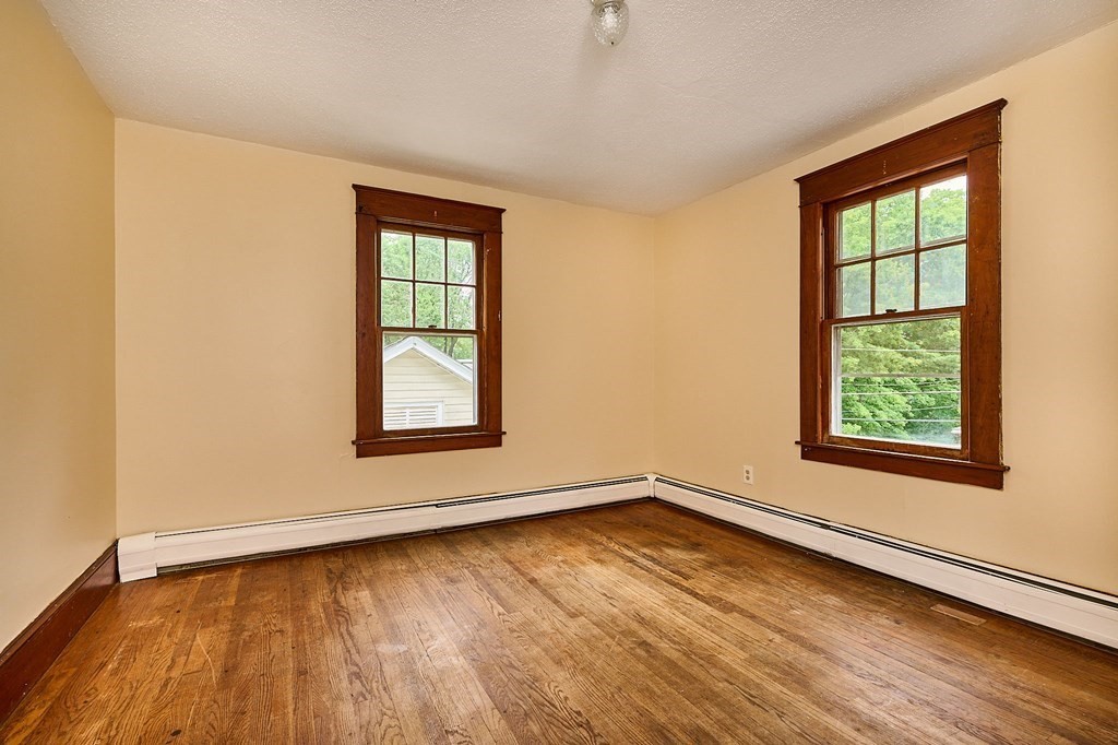 19 Powell Street Northampton, MA 01062 - Photo 16 of 40 an empty room with wooden floor and windows
