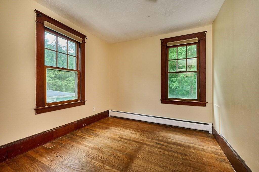 19 Powell Street Northampton, MA 01062 - Photo 18 of 40 an empty room with wooden floor and windows