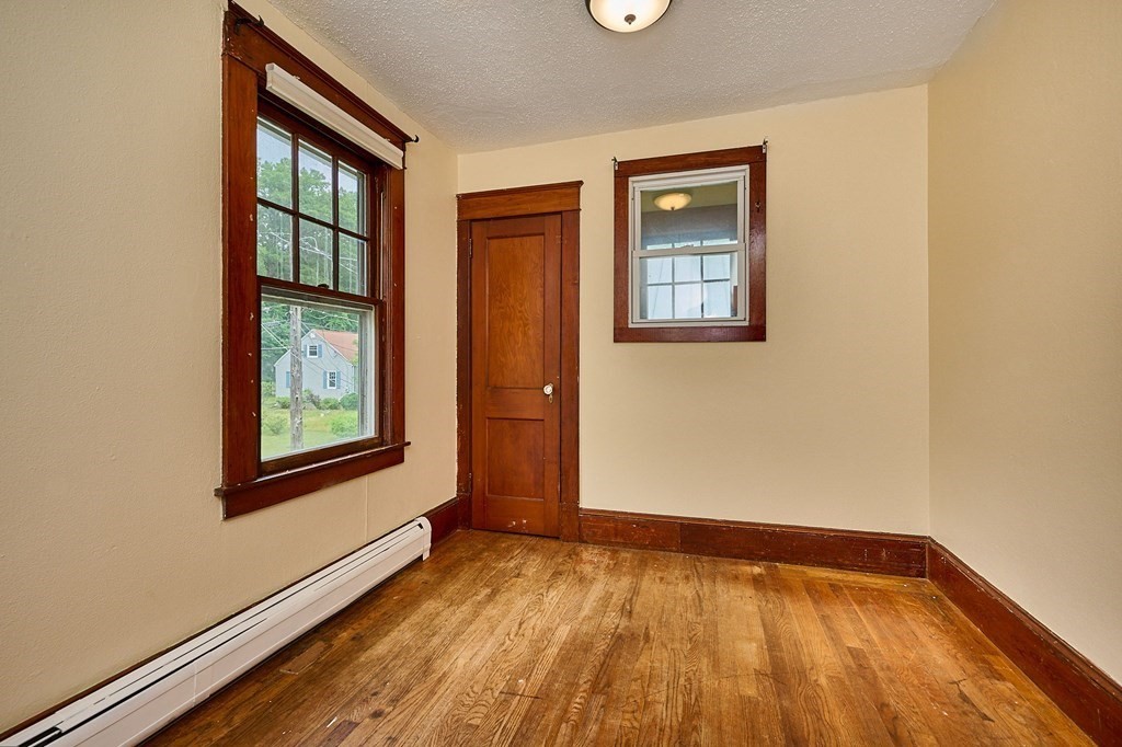 19 Powell Street Northampton, MA 01062 - Photo 19 of 40 an empty room with wooden floor and windows