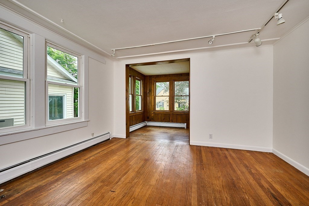 19 Powell Street Northampton, MA 01062 - Photo 5 of 40 a view of an empty room with wooden floor and a window