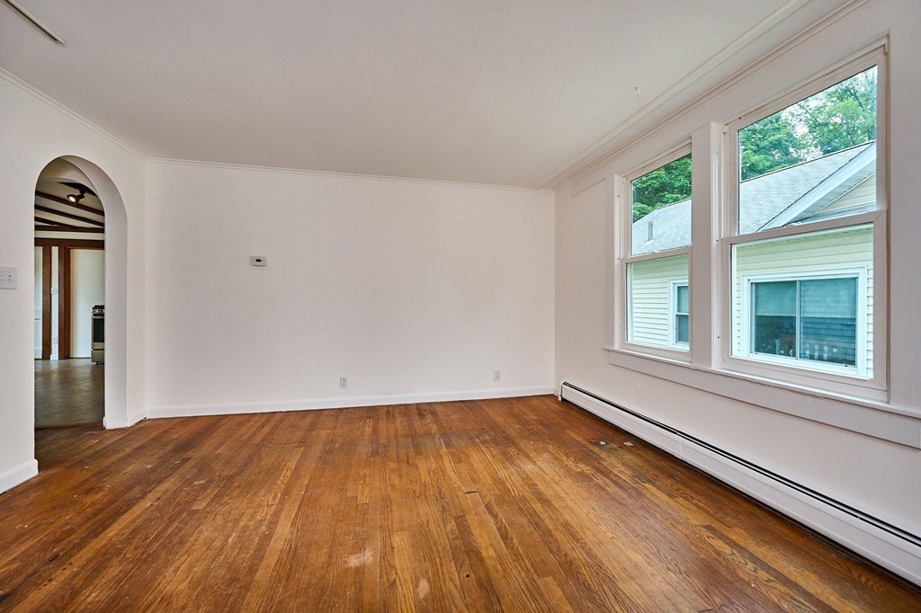 19 Powell Street Northampton, MA 01062 - Photo 6 of 40 a view of empty room with wooden floor and fan