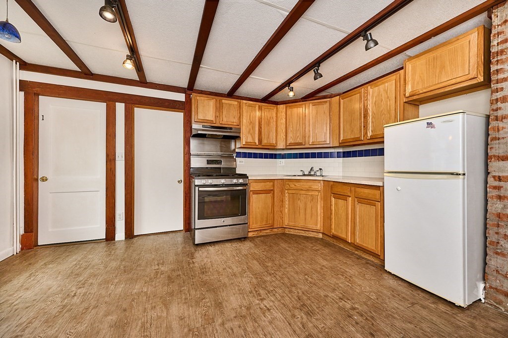 19 Powell Street Northampton, MA 01062 - Photo 8 of 40 a kitchen with white cabinets and white appliances