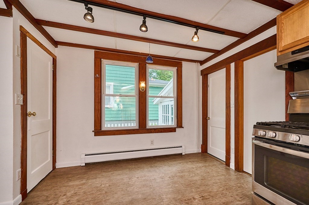 19 Powell Street Northampton, MA 01062 - Photo 9 of 40 a view of an empty room with a fireplace and a window