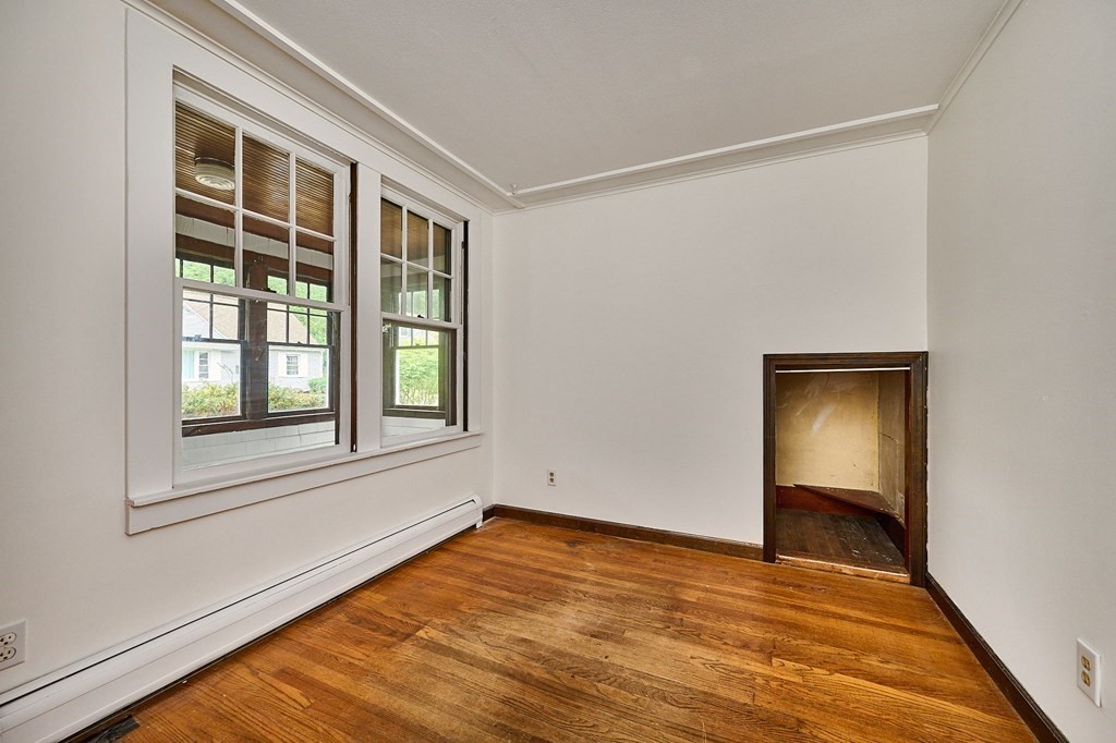 19 Powell Street Northampton, MA 01062 - Photo 10 of 40 a view of an empty room with wooden floor and a window
