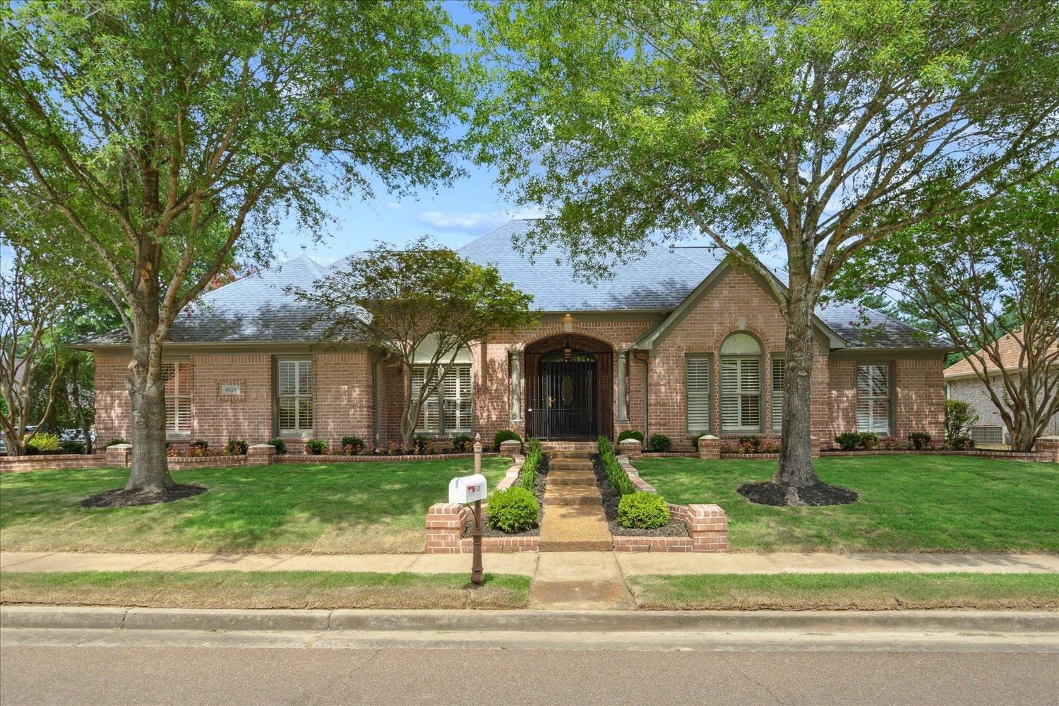 a front view of a house with a yard