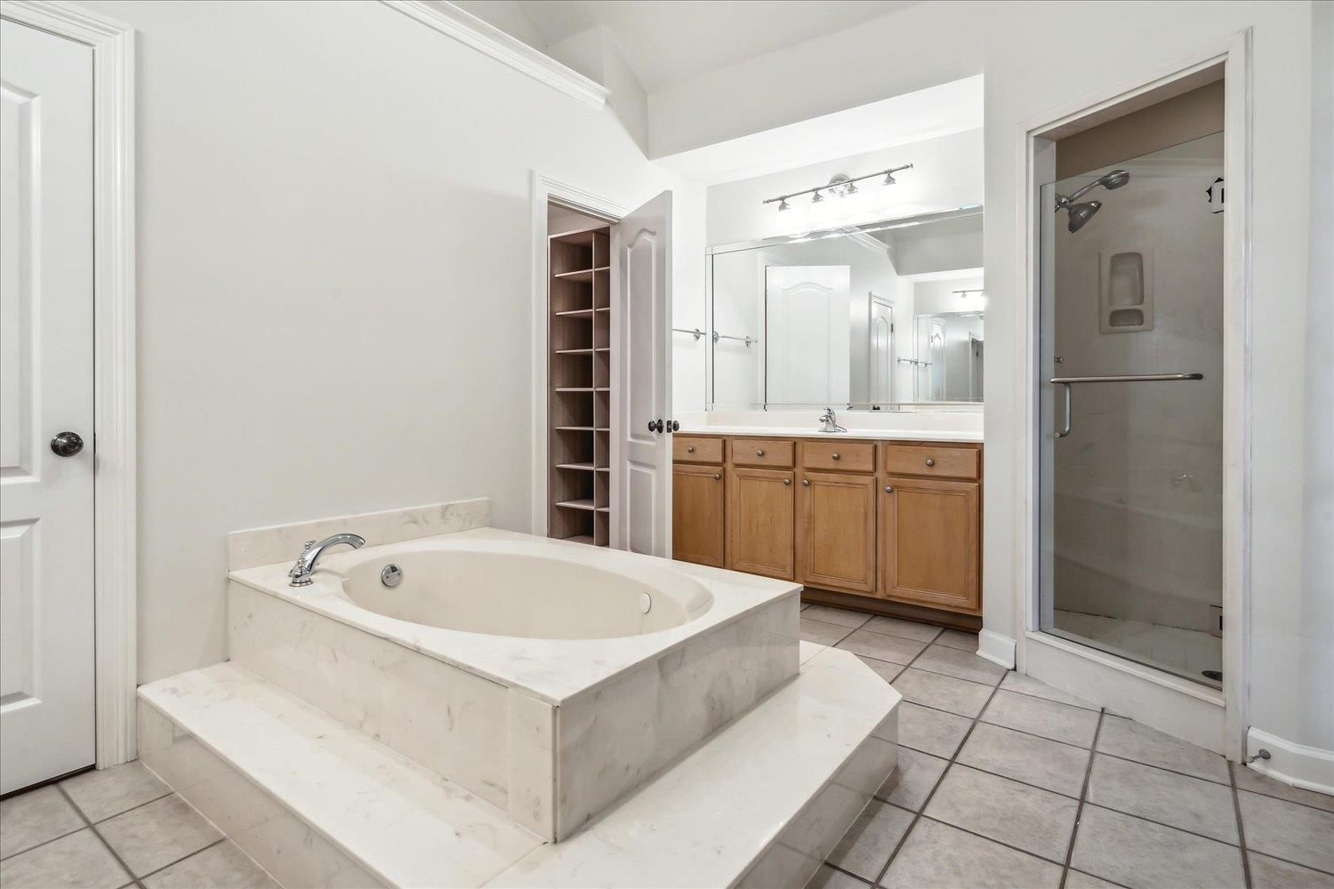 9128 Raspberry Lane Cordova, TN 38016 - Photo 15 of 32 a bathroom with a tub a sink and a window