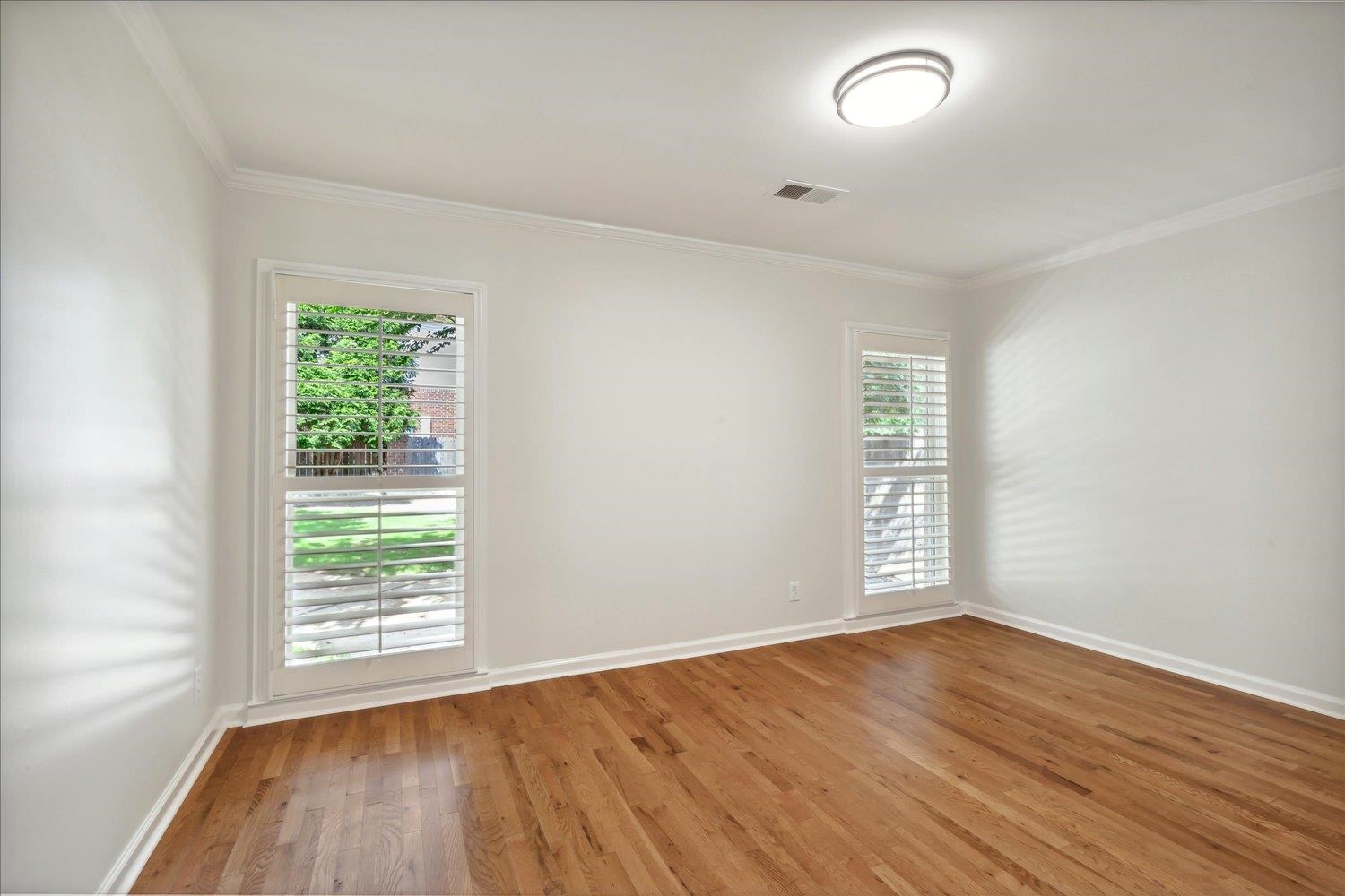 9128 Raspberry Lane Cordova, TN 38016 - Photo 19 of 32 an empty room with wooden floor and windows