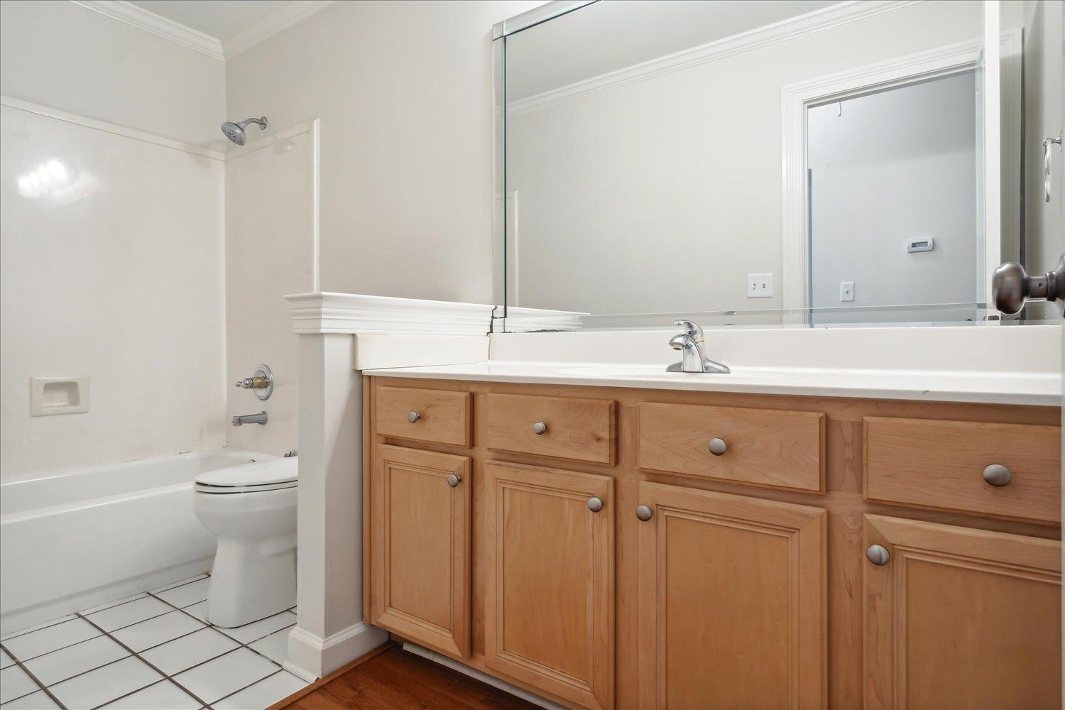 9128 Raspberry Lane Cordova, TN 38016 - Photo 20 of 32 a bathroom with a double vanity sink toilet mirror and bathtub