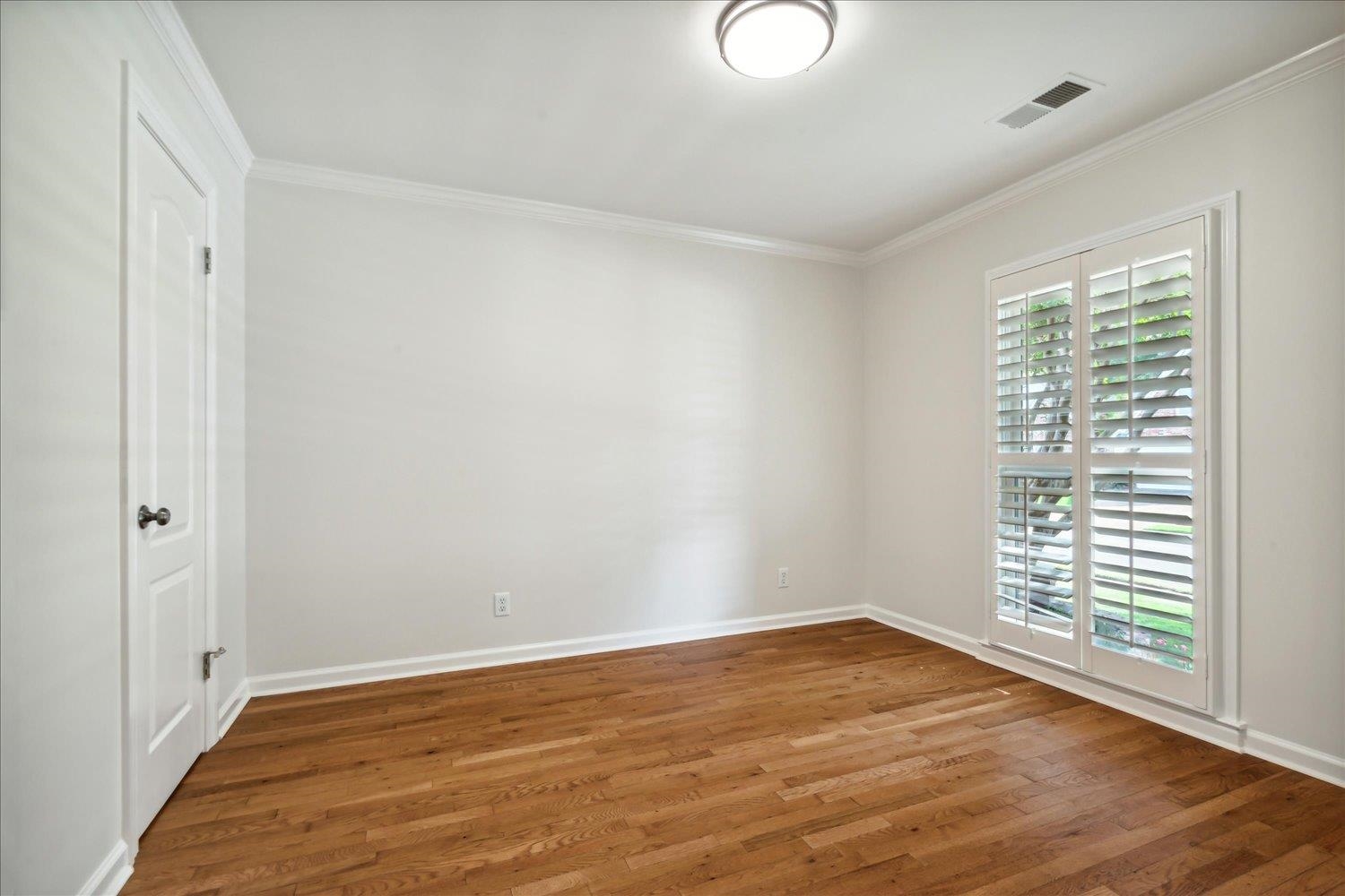 9128 Raspberry Lane Cordova, TN 38016 - Photo 21 of 32 a view of an empty room with wooden floor and a window